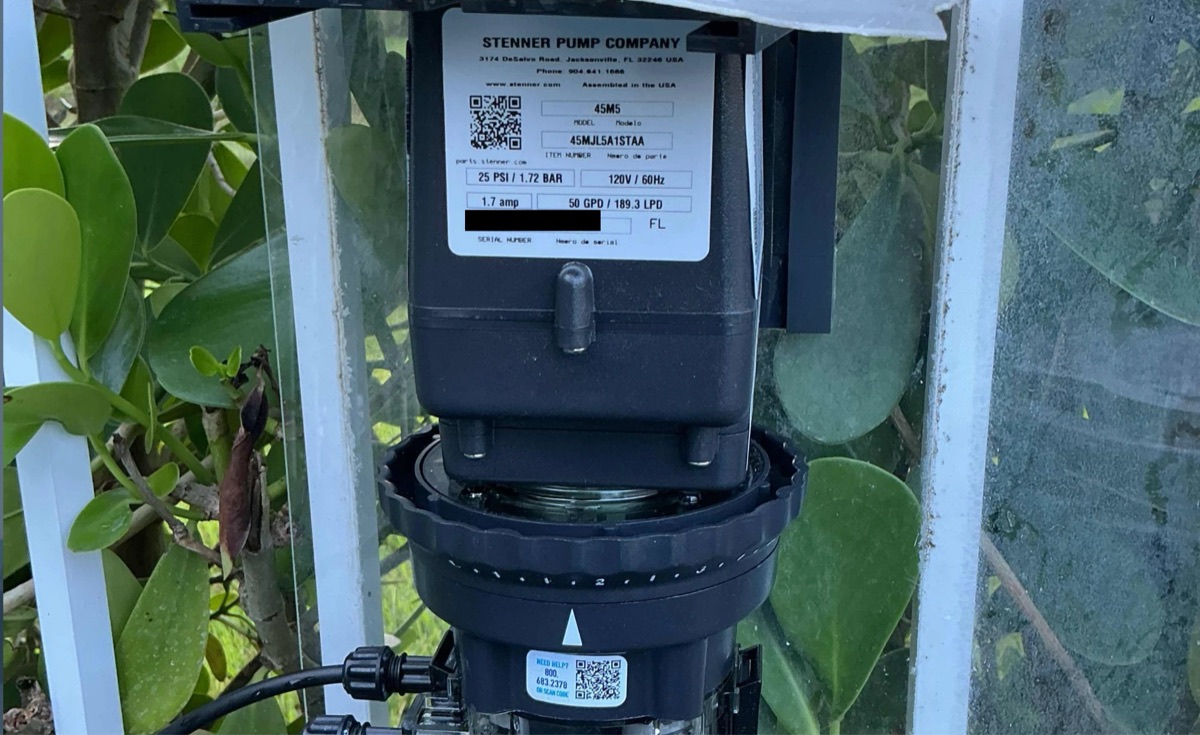 Stenner peristaltic pump nameplate showing model and specifications, installed by Guardian Pools